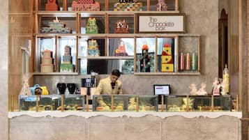 A chocolate-themed display with various confectionery items and a sign reading "The Chocolate Box".