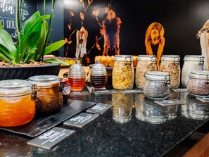 A food display with various jars of condiments and snacks. - ibis Joinville (Joinville)