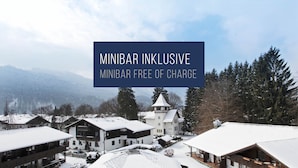 A snow-covered village with traditional buildings and a prominent tower. - HYPERION Hotel Garmisch – Partenkirchen (Garmisch-Partenkirchen)