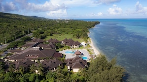 A coastal resort with multiple buildings, a swimming pool, and a beach. - Aqua Resort Club Saipan (Saipan)