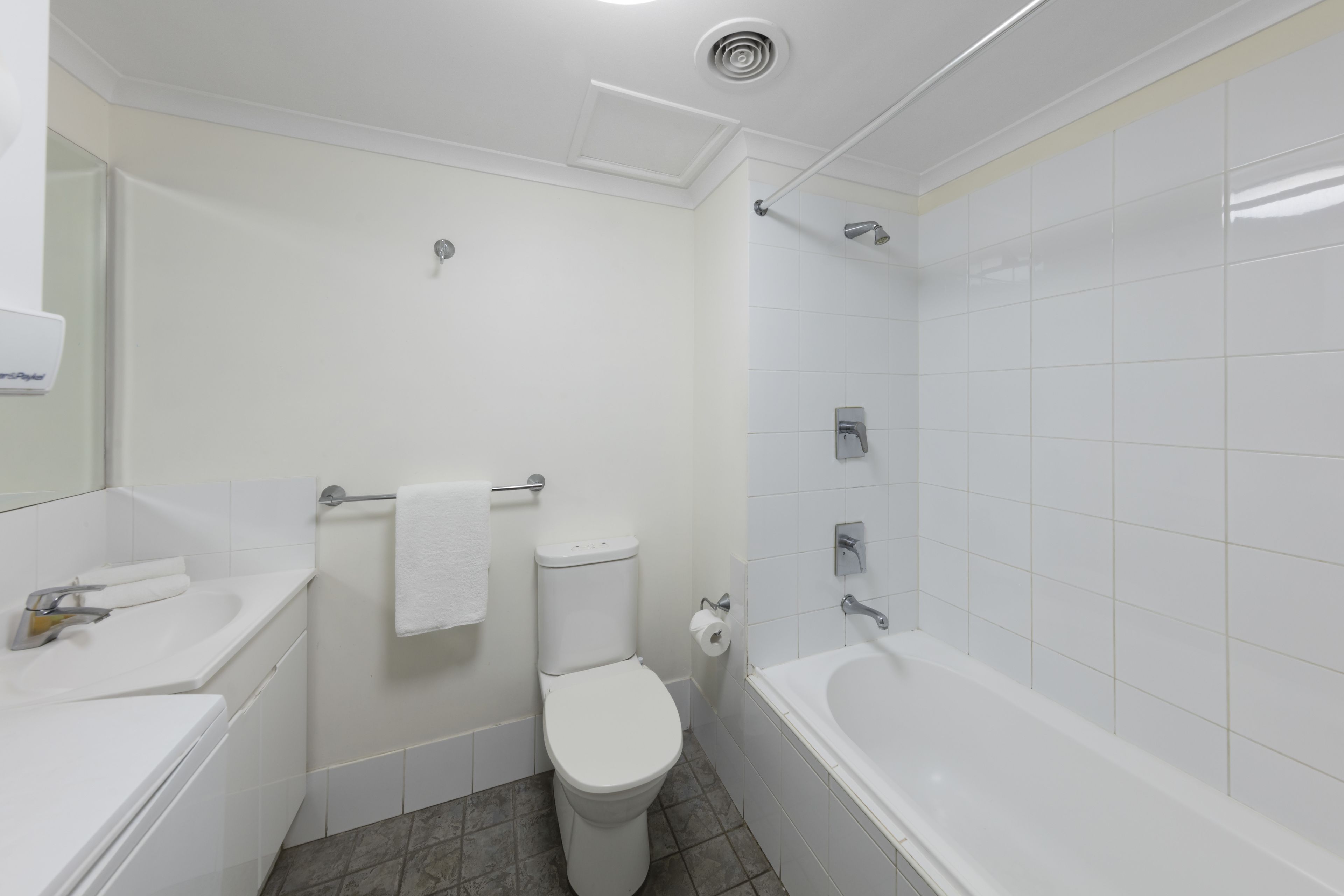 A bathroom with a toilet, sink, and bathtub.