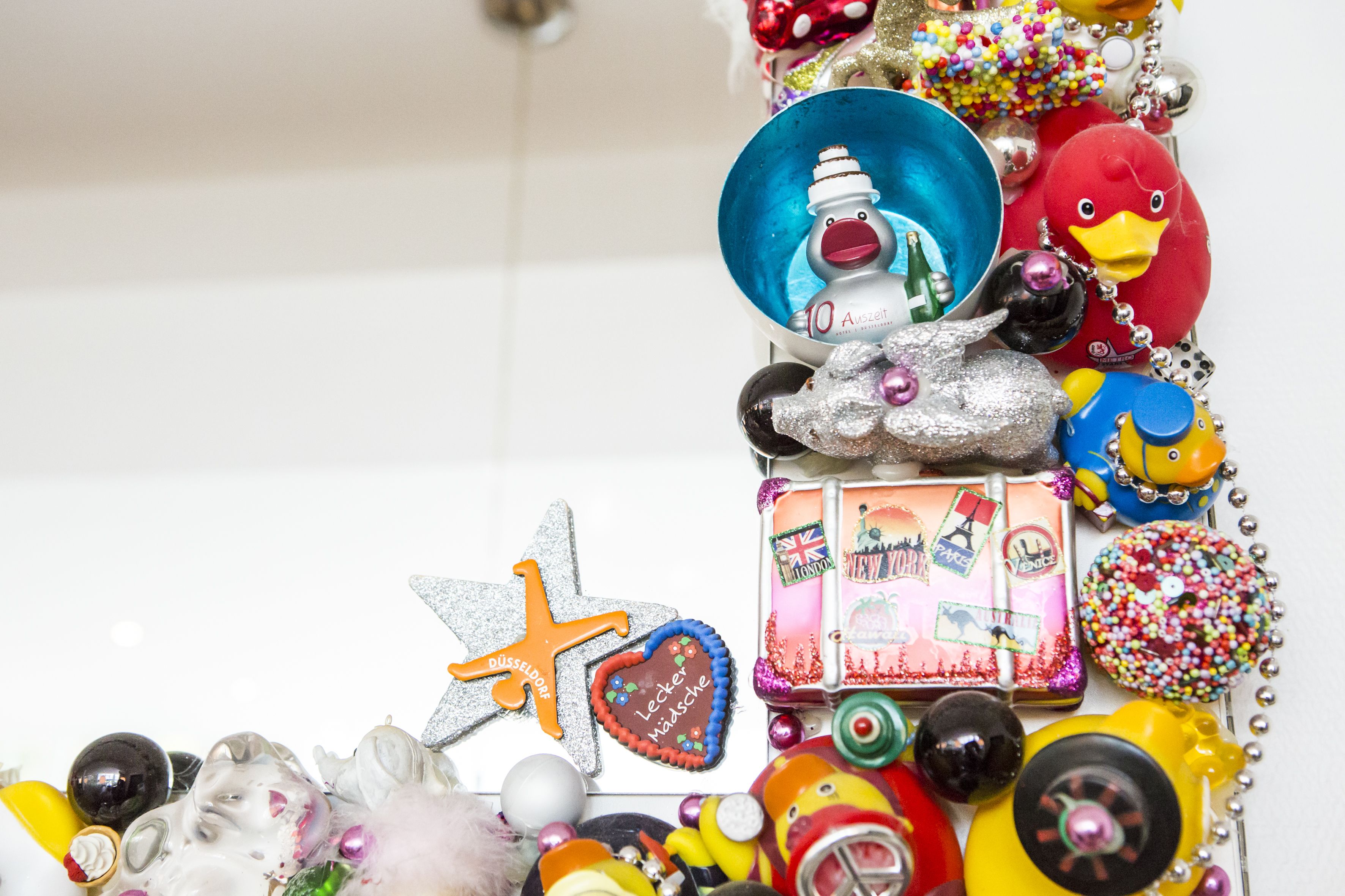 A collection of various toys and decorations, including a duck, a toy car, and a star-shaped ornament.
