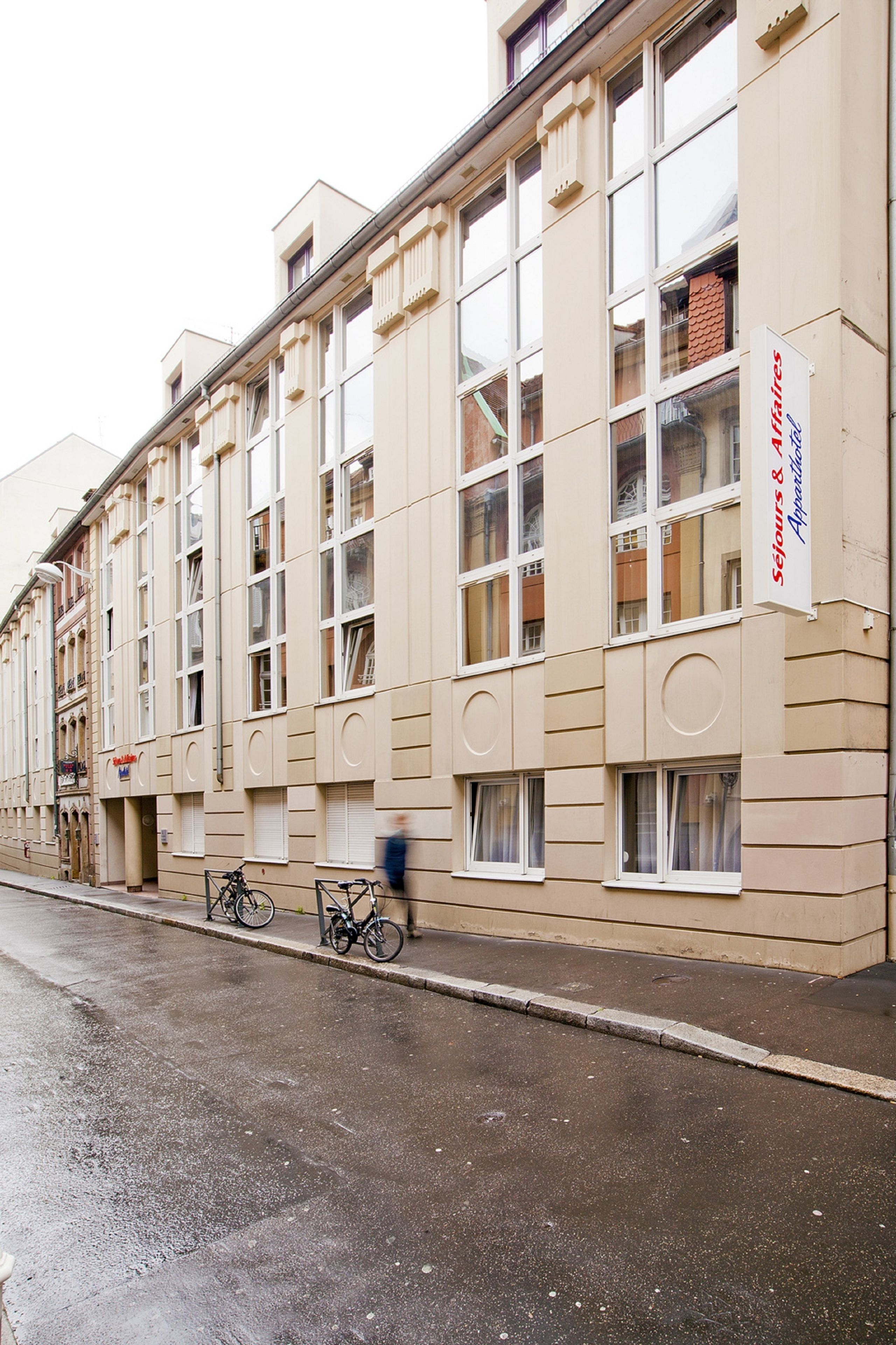 Ein mehrstöckiges Gebäude mit großen Fenstern und einem Schild mit der Aufschrift 'Sejlers & Appetites'.