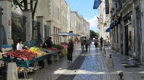 A street market with vendors selling fruits and vegetables. - Séjours & Affaires La Rochelle Les Minimes (La Rochelle)