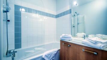 Bathtub, eco-friendly toiletries, hair dryer, towels