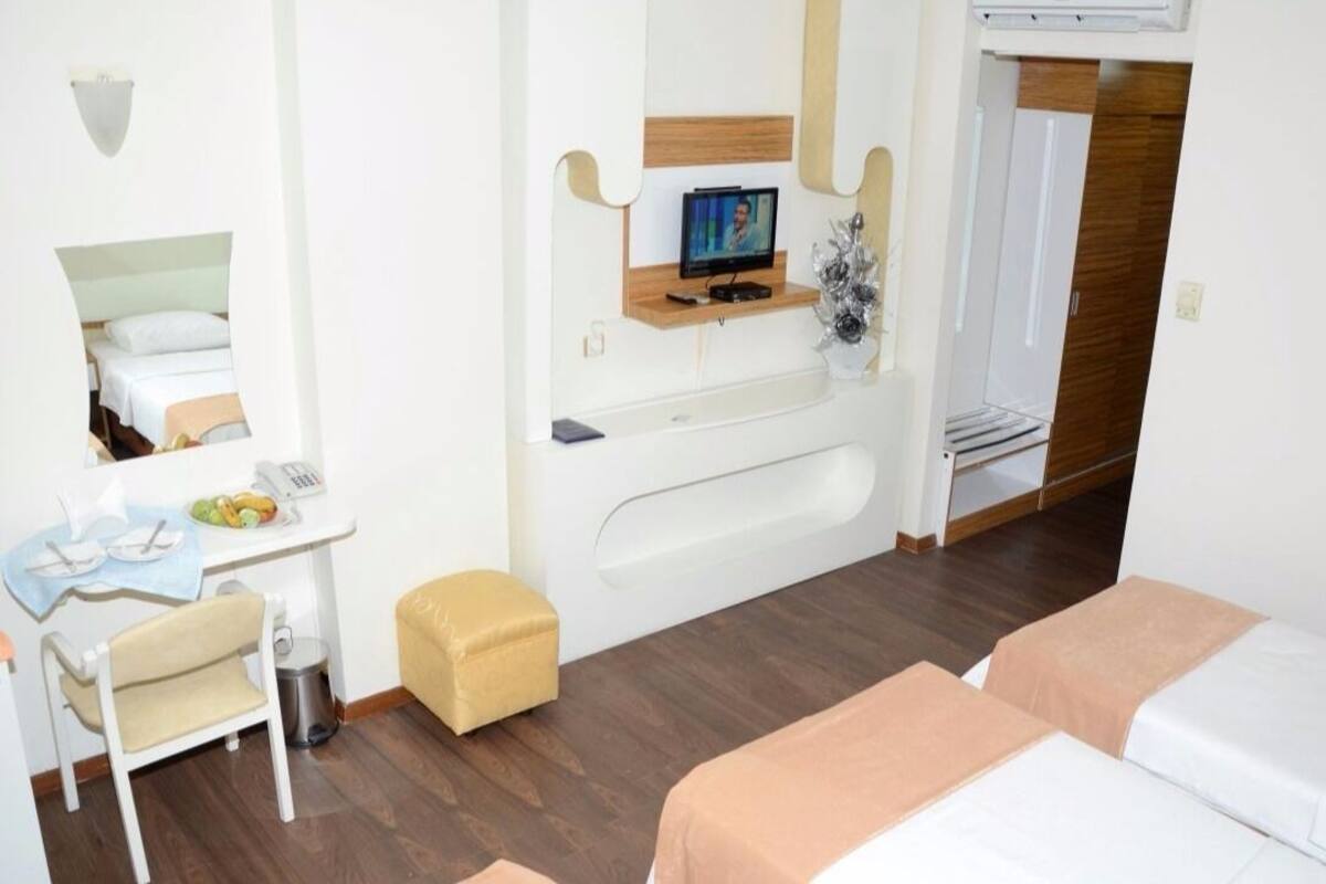 Triple Room | Minibar, in-room safe, desk, iron/ironing board