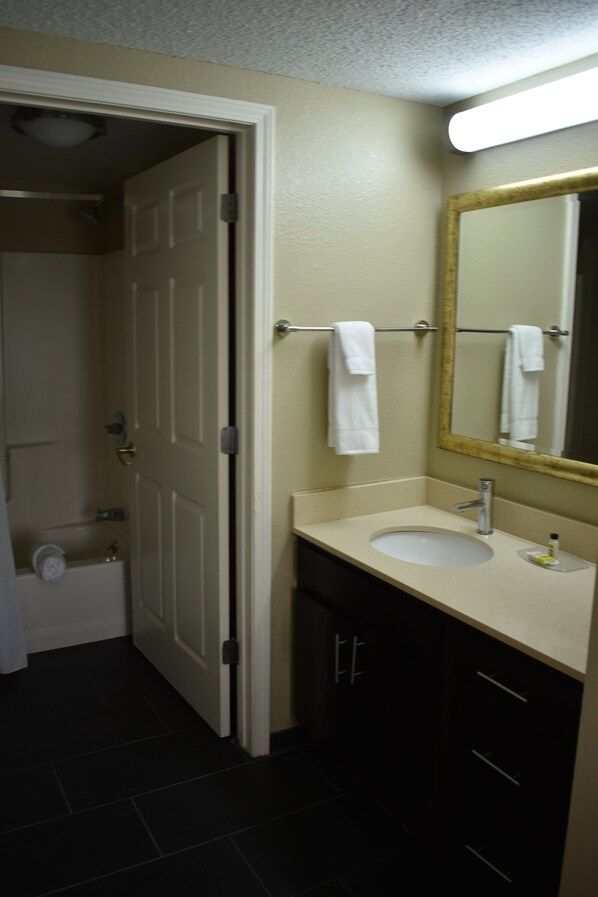 A bathroom with a white sink, a mirror, and a towel rack. - Staybridge Suites Cranbury by IHG (Cranbury)