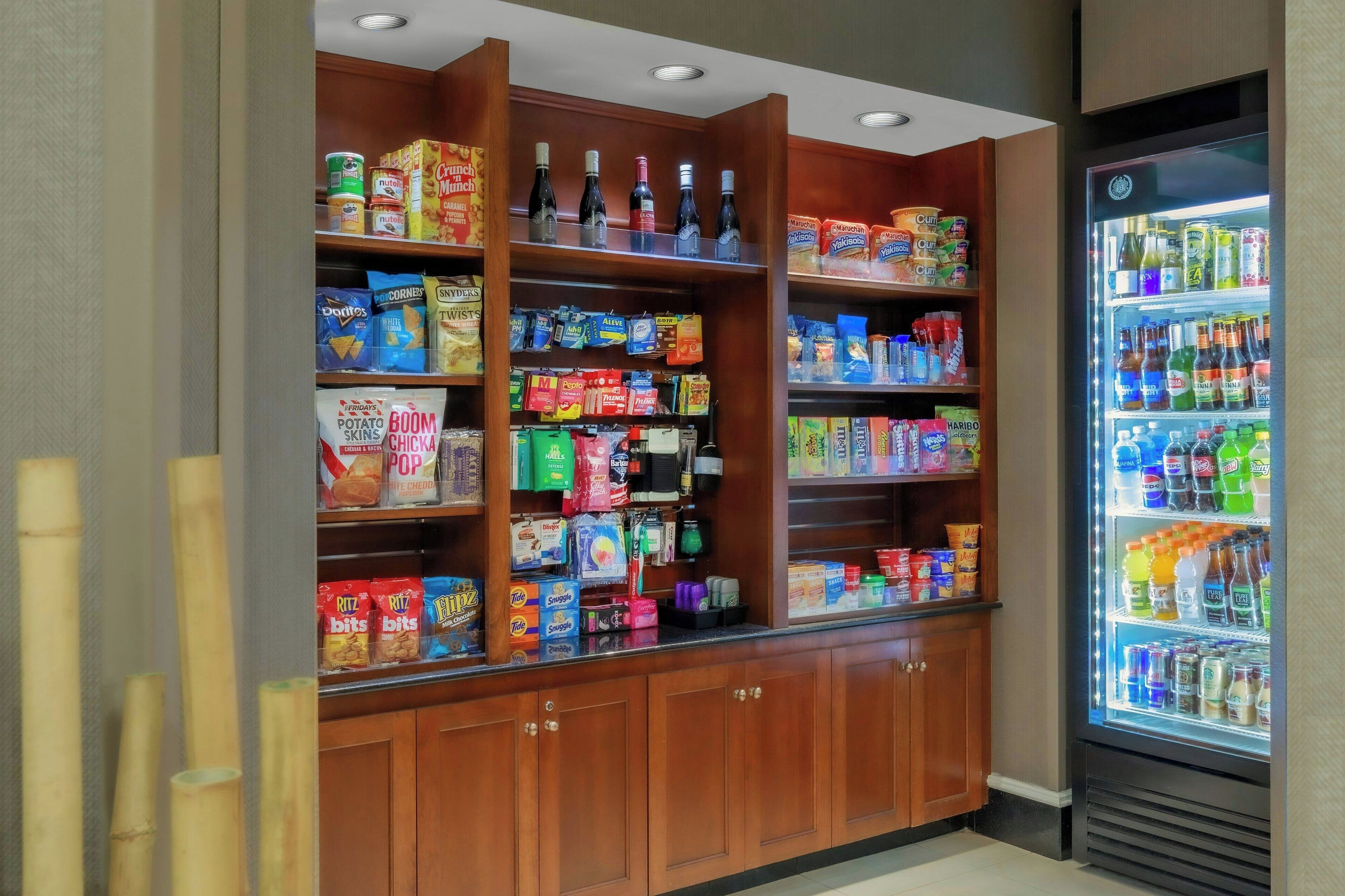 A self-service snack and beverage kiosk with various food and drink options.