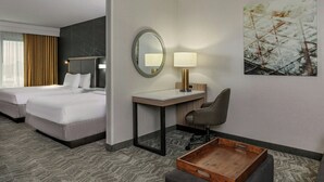 A hotel room with two beds, a desk with a lamp, a chair, a tray table, and a painting on the wall. - SpringHill Suites by Marriott Norfolk Virginia Beach (Norfolk)