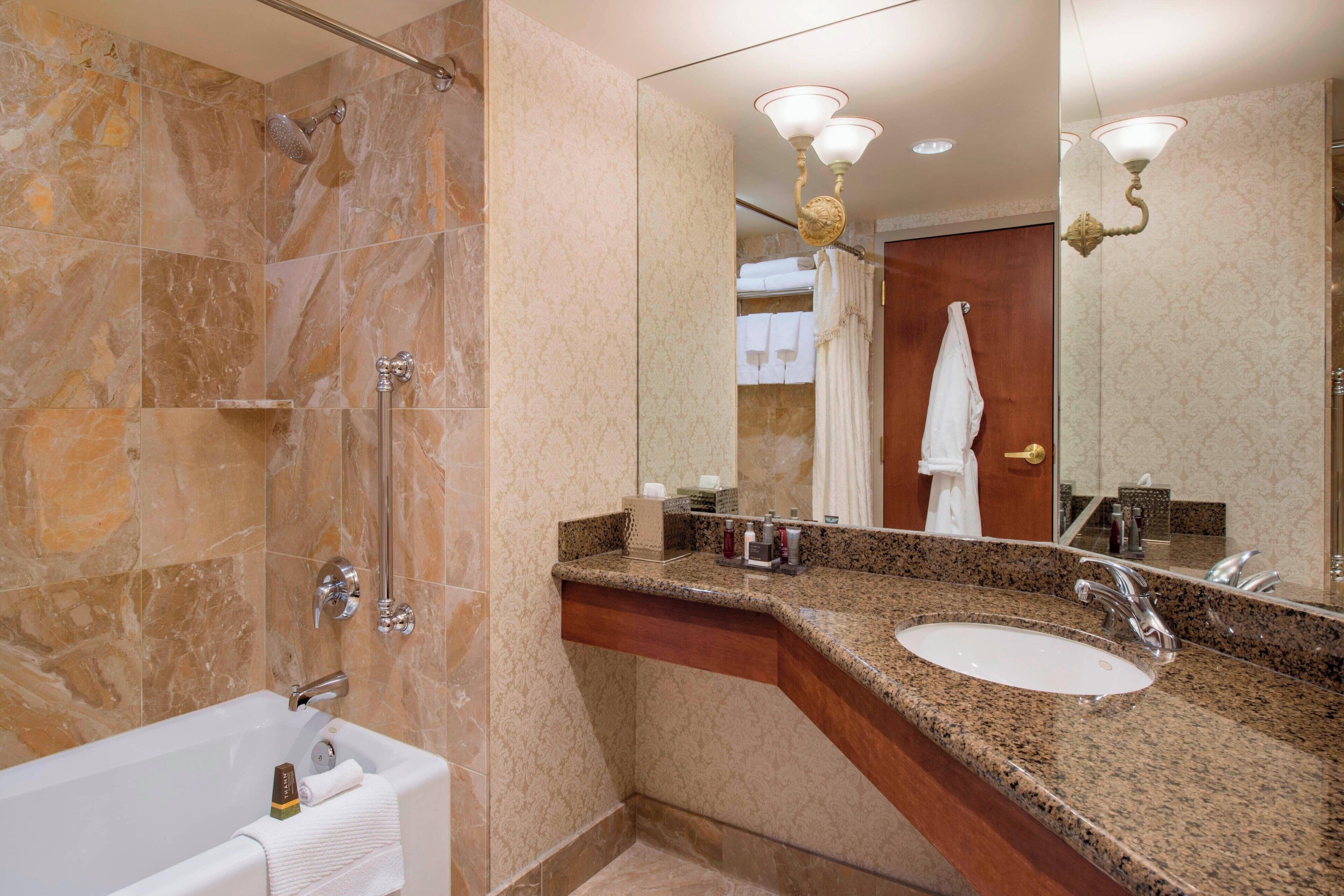 combined shower/bathtub, designer toiletries, hair dryer, towels
