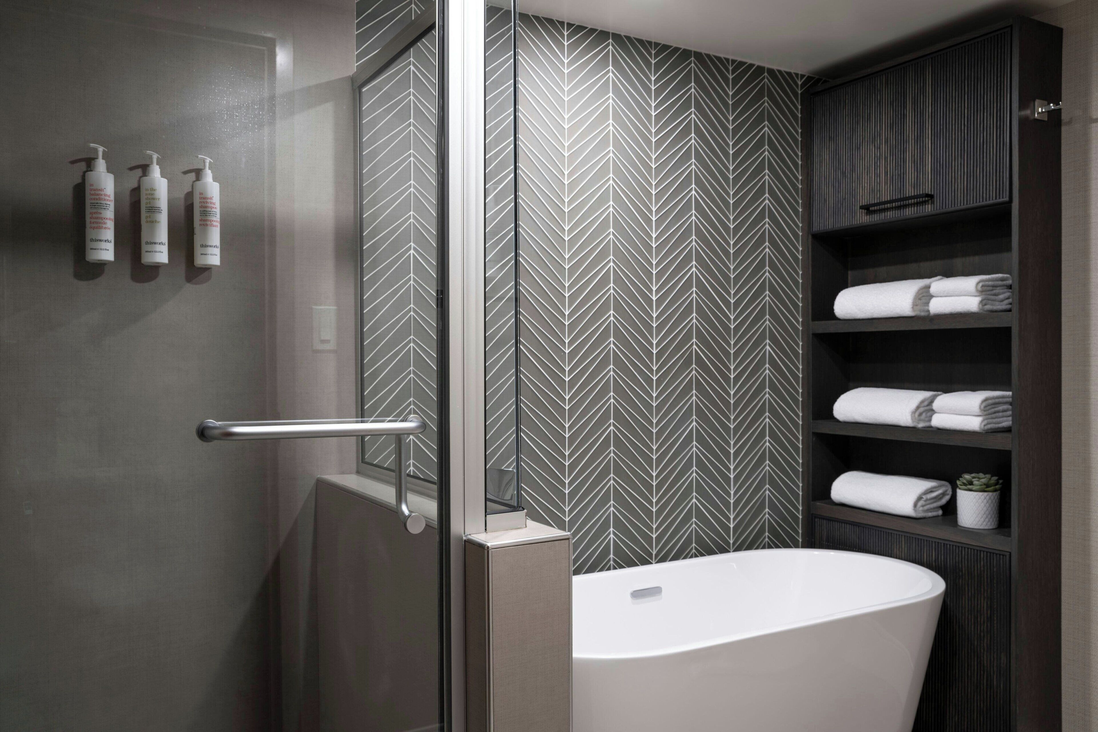 combined shower/bathtub, designer toiletries, hair dryer, towels