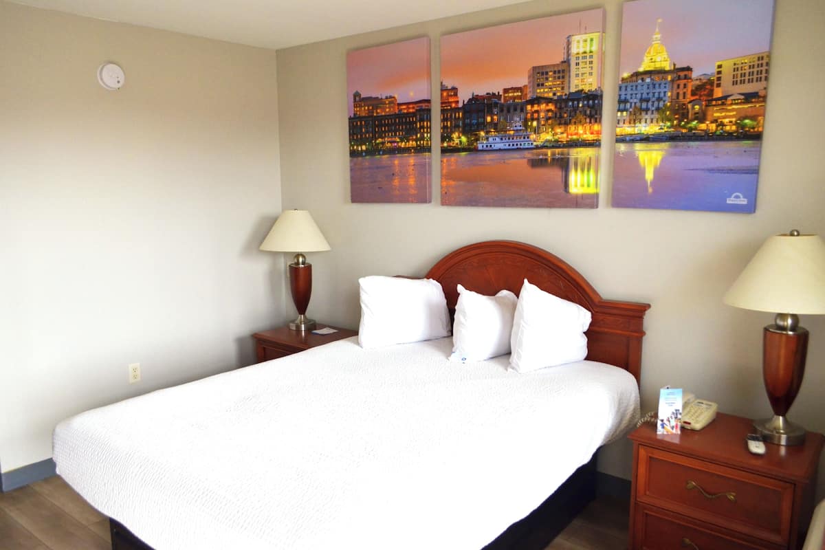 Hypo-allergenic bedding, desk, laptop workspace, blackout drapes