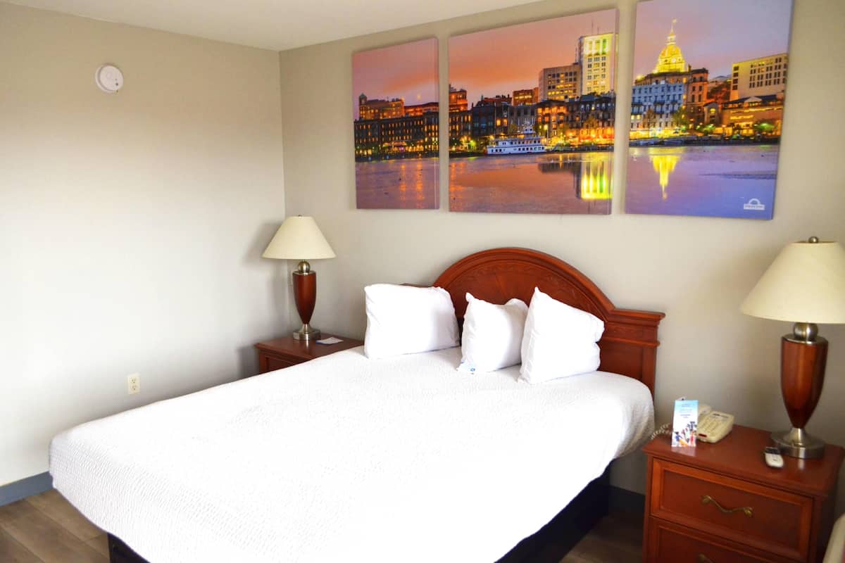 Hypo-allergenic bedding, desk, laptop workspace, blackout drapes