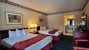 A hotel room with two beds, a desk, a mirror, and a bathroom visible through an open door. - Americas Best Value Inn Sky Ranch Palo Alto (Palo Alto)