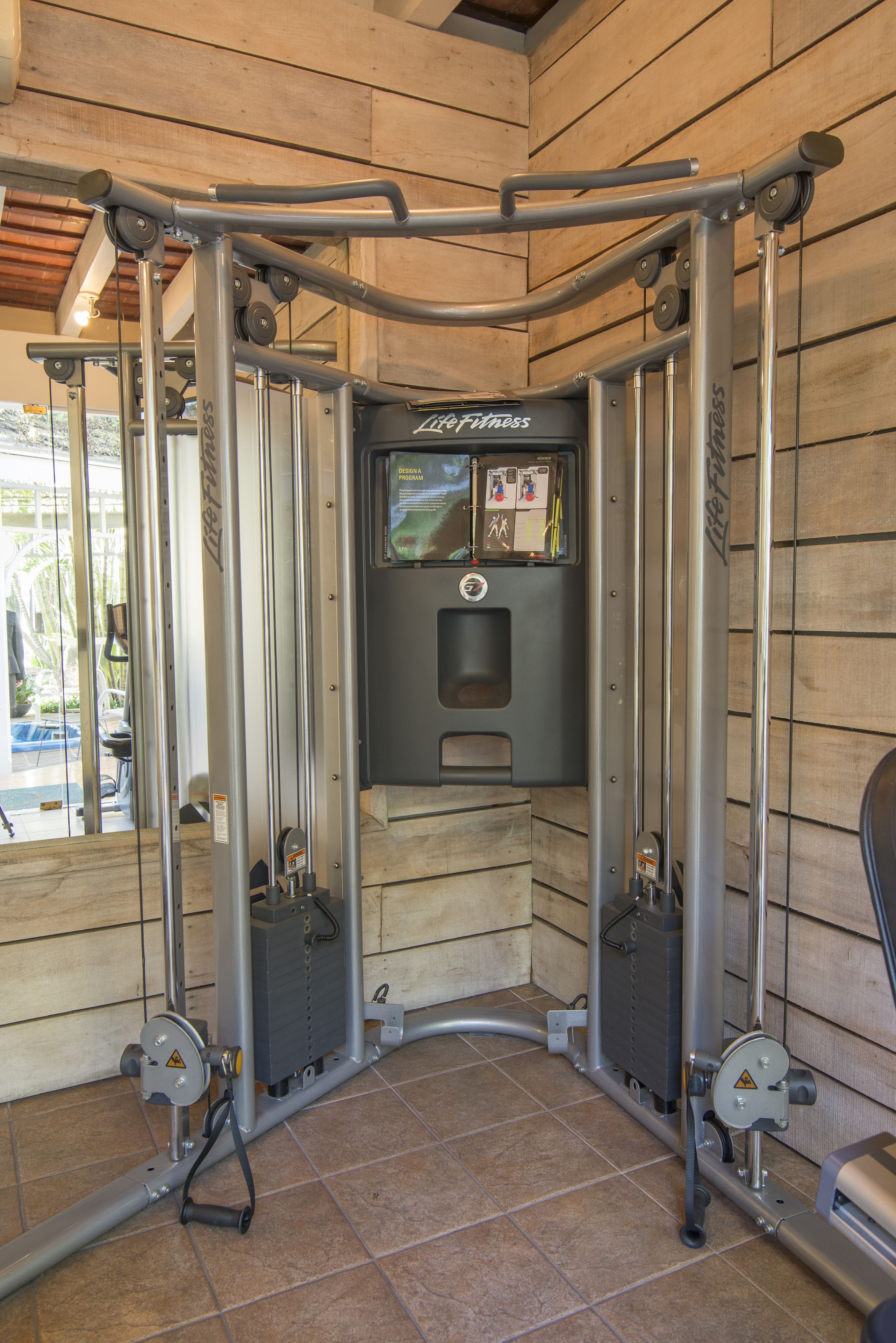 A gym with a pull-up bar, a weight machine, and a digital display.