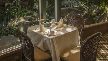 Mesa lista para dos con vistas a exuberante vegetación.