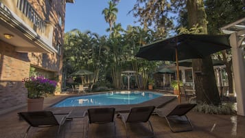 Outdoor pool, open 8:00 AM to 8:00 PM, pool umbrellas
