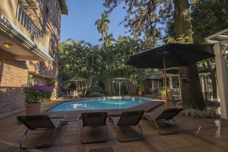 Outdoor pool, open 8:00 AM to 8:00 PM, pool umbrellas
