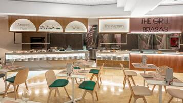 A modern restaurant with a buffet setup, including sections labeled 'Arroces Rice', 'La trattoria', and 'Wok'.