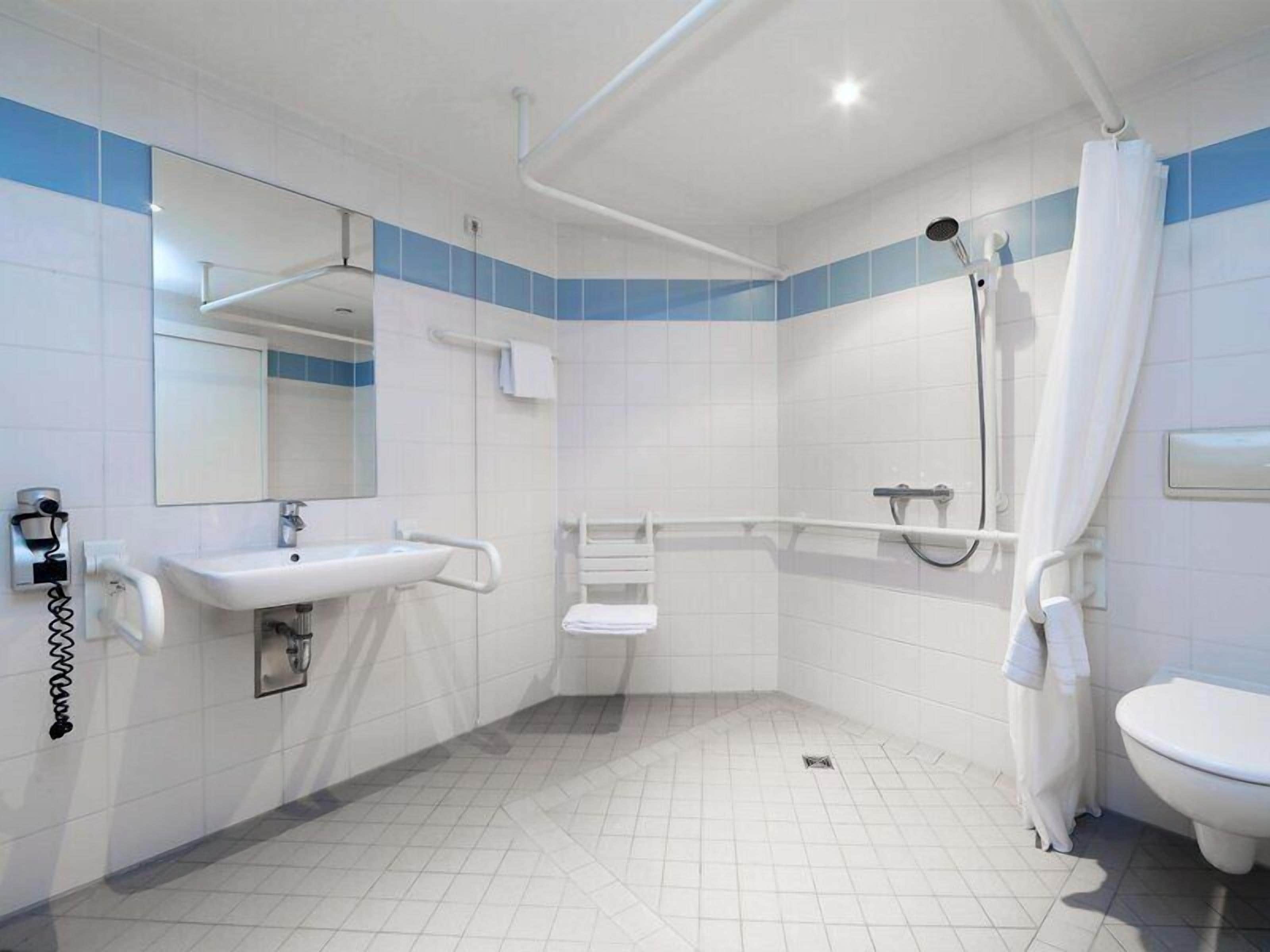Twin kamer, rolstoeltoegankelijke douche | Badkamer | Een douche, een haardroger, handdoeken