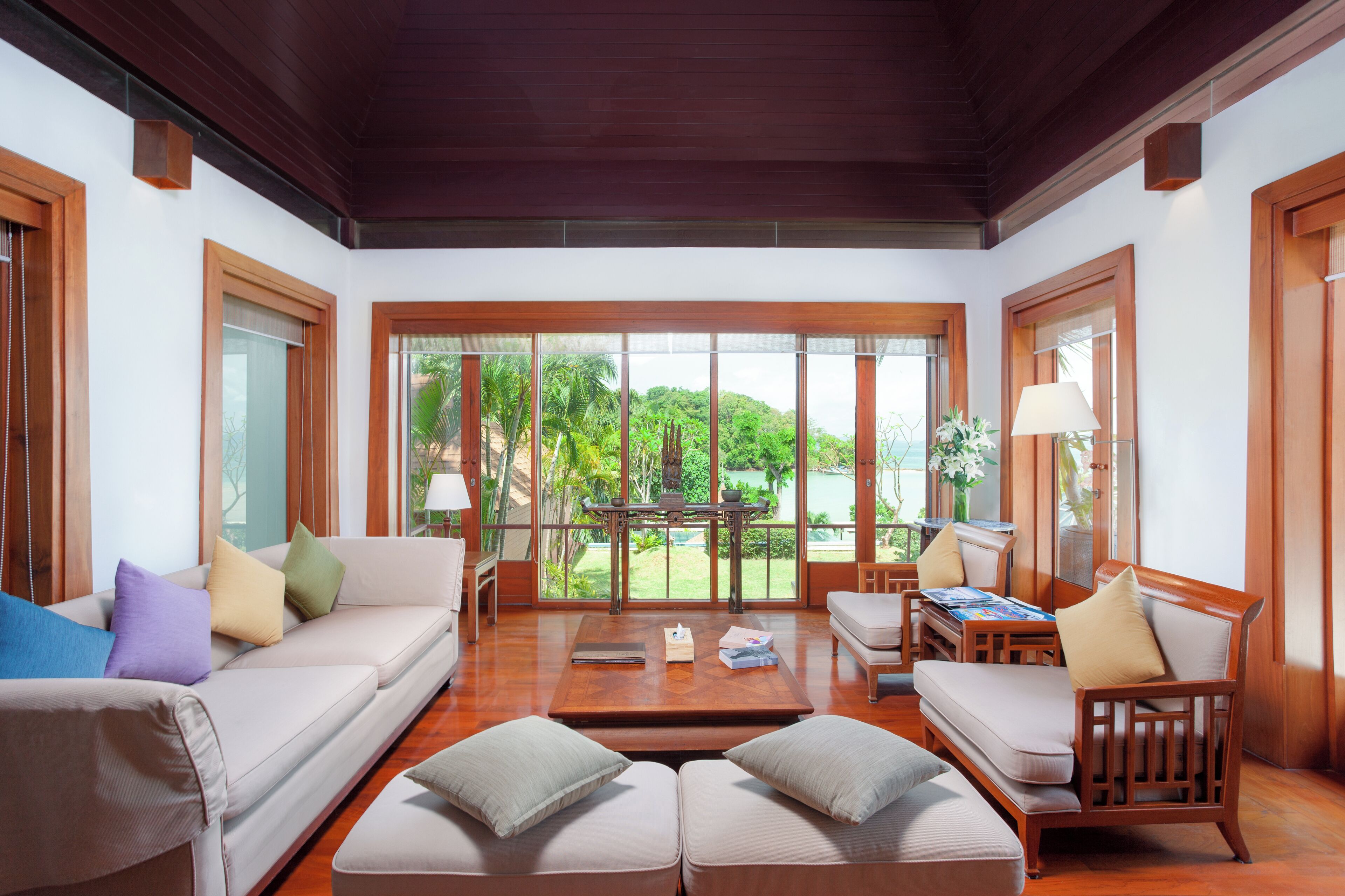 A spacious living area with a sofa, a coffee table, and a wooden chair.