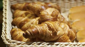 A wicker basket filled with croissants.