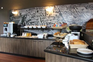 A buffet setup with various food items and a coffee station. - Bastion Hotel Bussum Hilversum (Bussum)