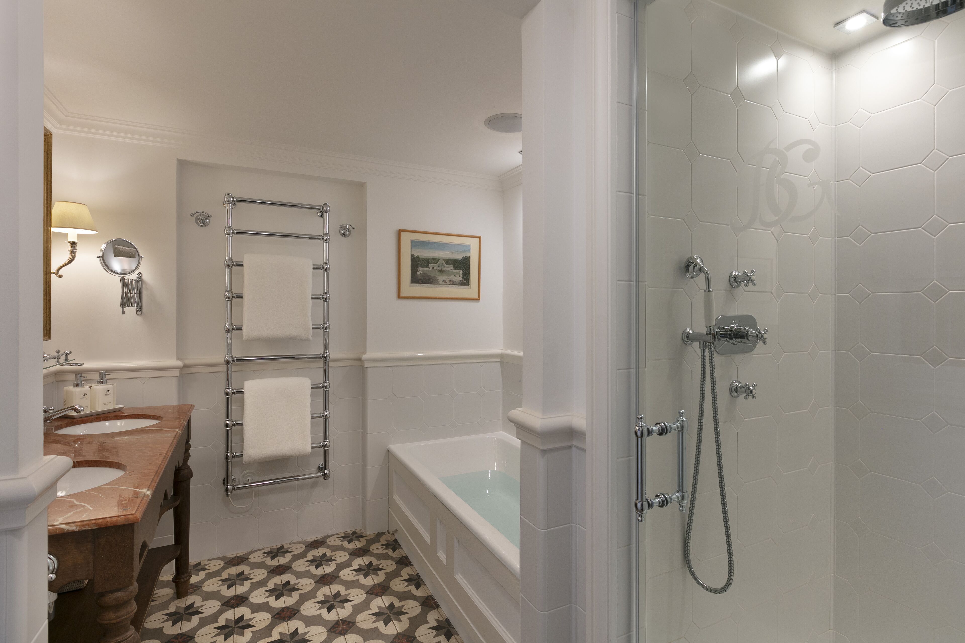 A bathroom with a double sink vanity, a bathtub, and a shower area.