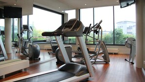 A gym with treadmills, stationary bikes, and other fitness equipment.