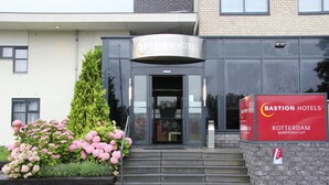 A modern building with a sign for Bastian Hotel in Rotterdam.