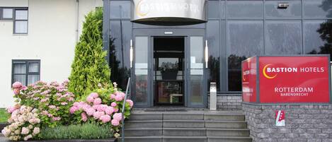 A modern building with a sign for Bastian Hotel in Rotterdam.