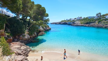 On the beach, white sand, sun-loungers, beach umbrellas