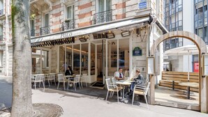 A cafe with outdoor seating, a visible entrance, and a sign indicating the name 'POLO'. - HotelHome Paris 16 (Paris)