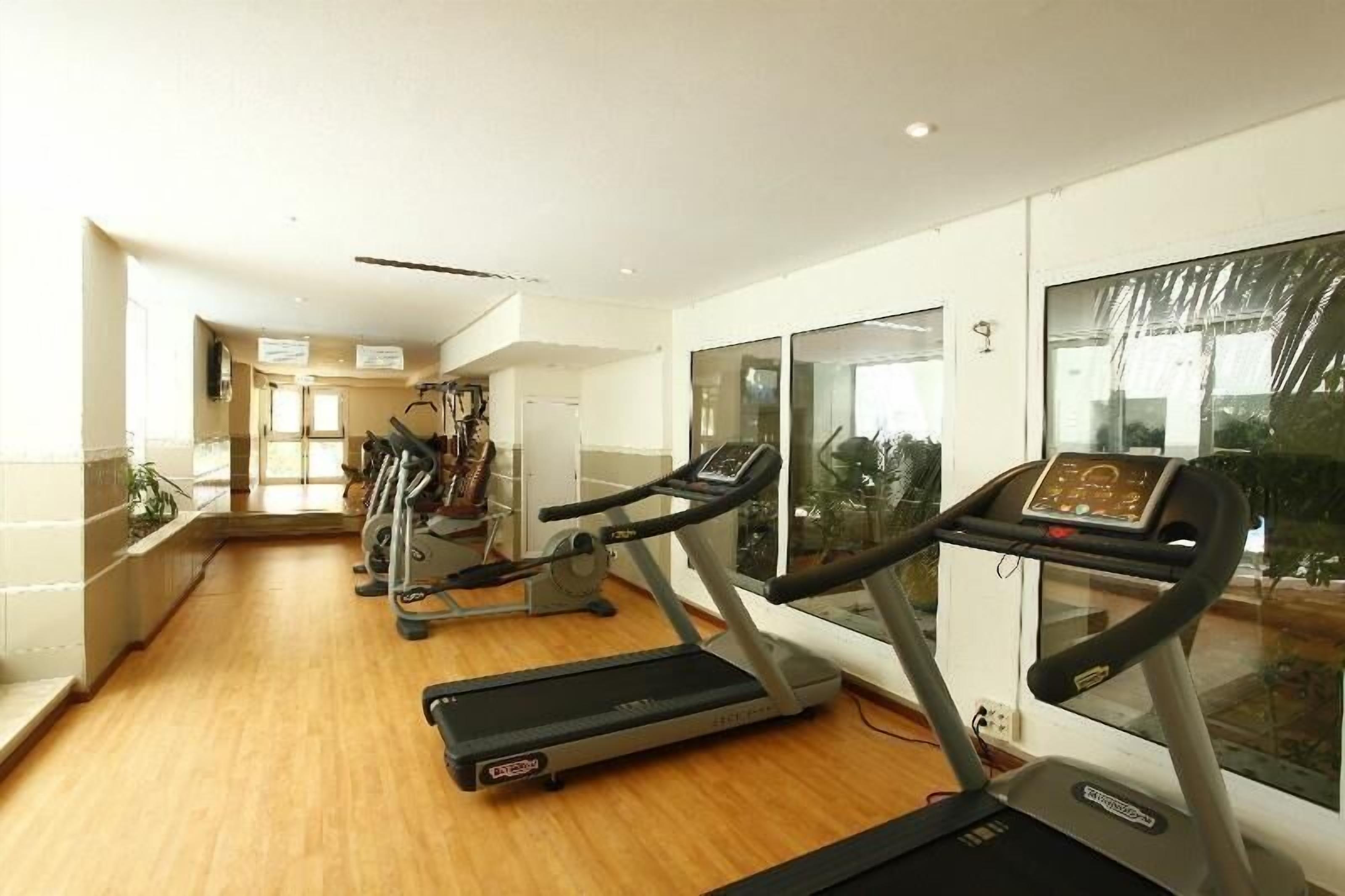 A gym with treadmills, a stationary bike, and a rowing machine.