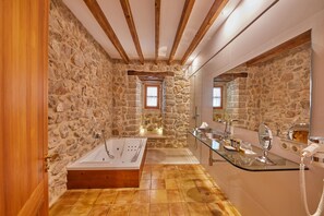 Separate tub and shower, designer toiletries, hair dryer, bathrobes