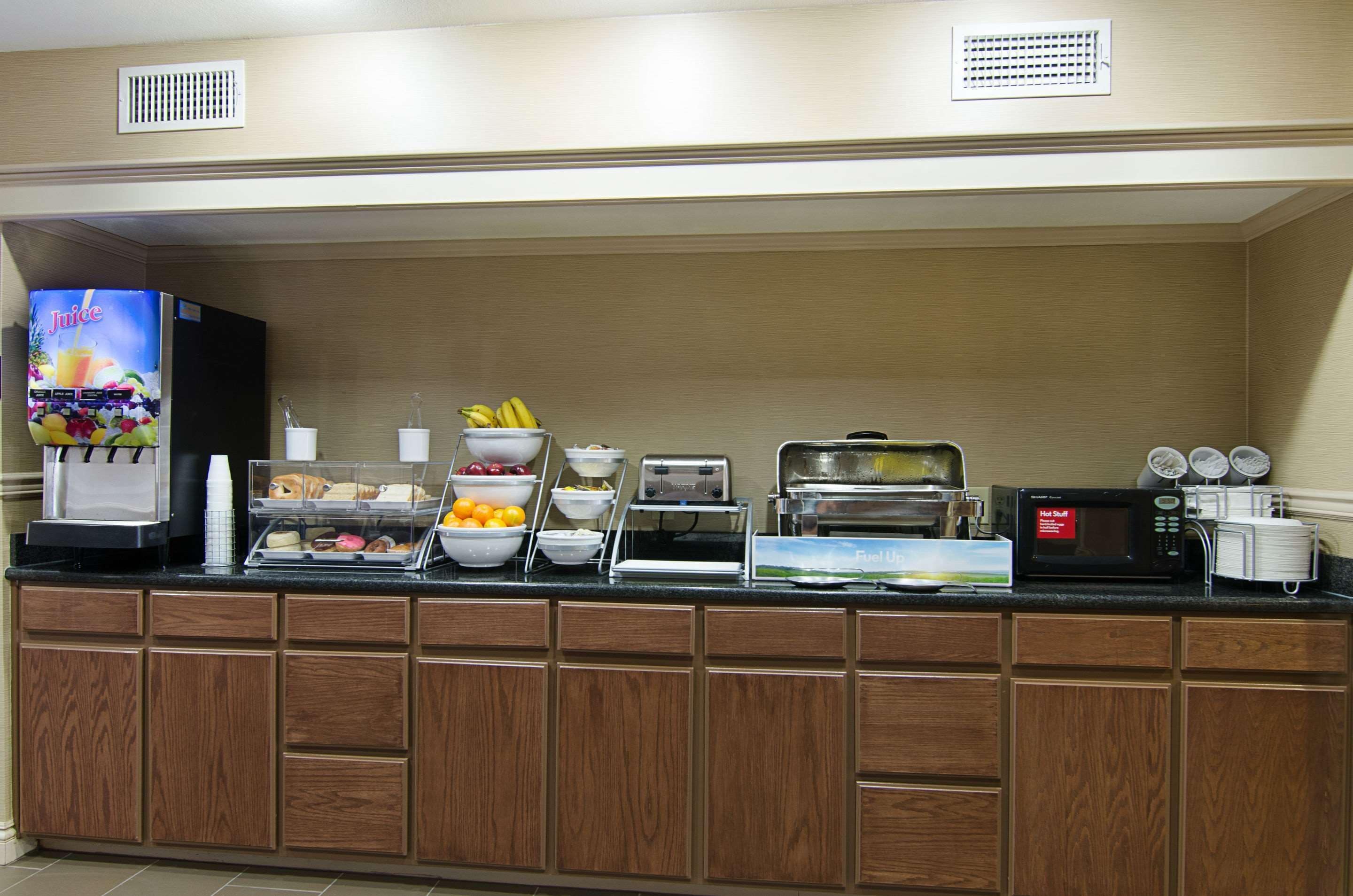 A buffet setup with various food items and appliances.