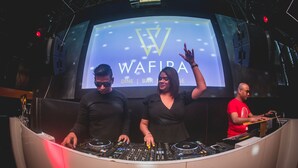A DJ booth with a large screen displaying "WAFIRA DINE BAR" in the background. - Golden Parkk (Kolkata)