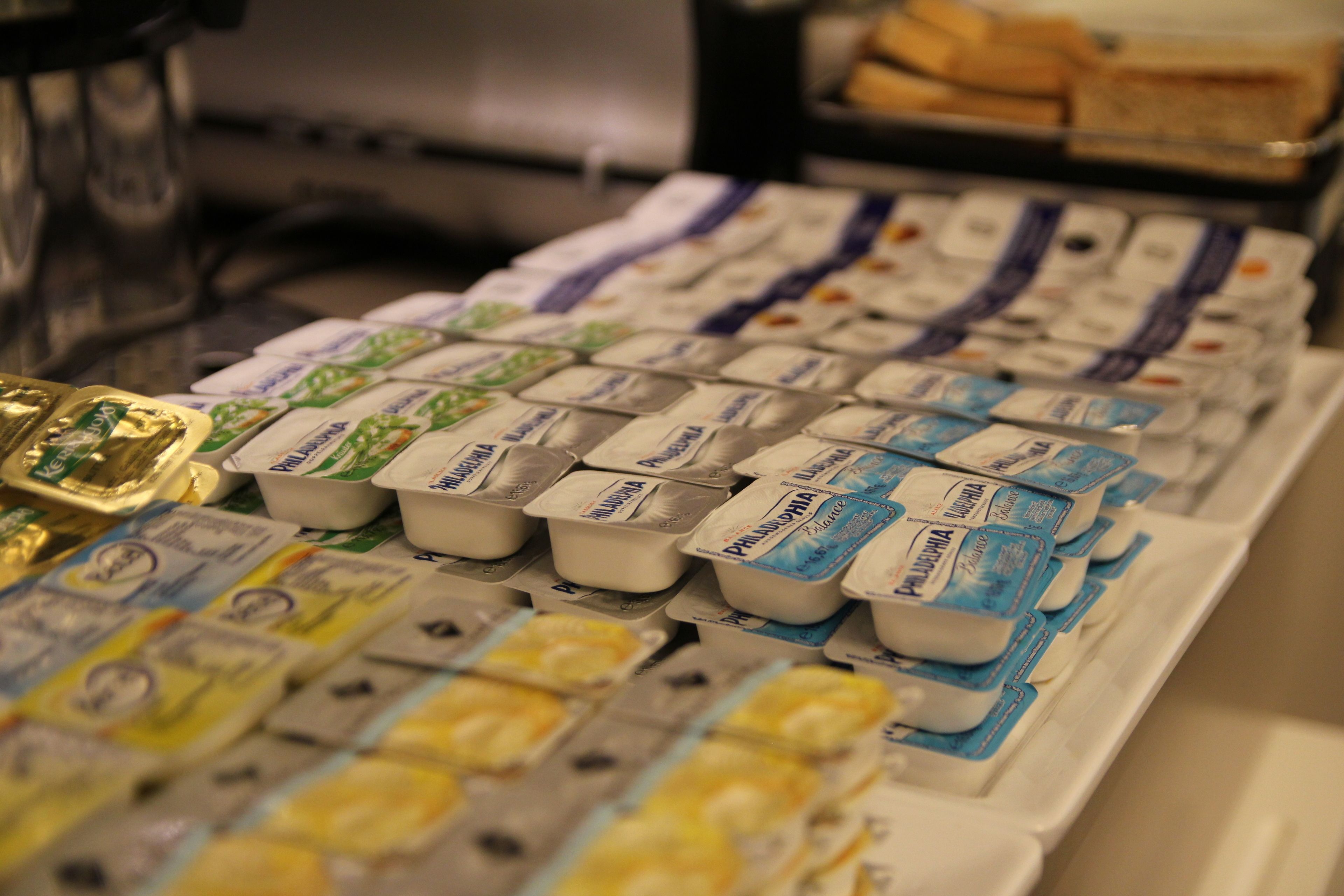 A display of packaged food items, including yogurt and cheese, arranged on a table.