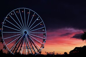 A large Ferris wheel with a dark sky and a sunset in the background. -  Trouville Bournemouth - OCEANA COLLECTION (Bournemouth)