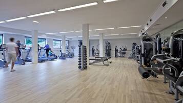 A gym with treadmills, weight machines, and free weights.