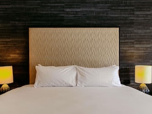A hotel room with a large bed, two bedside lamps, and a textured headboard. -  Peppers Clear Mountain (Cashmere)