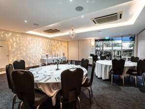 A well-lit conference room with round tables, chairs, and a chandelier. -  Peppers Clear Mountain (Cashmere)