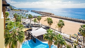 A resort with a swimming pool, beach, and marina.