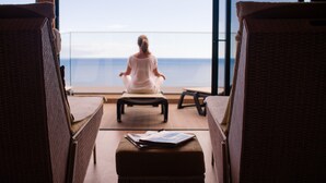 A person meditating on a balcony with a view of the sea. - Hotel Alpino Atlantico Ayurveda Cure Centre - Adults Only (Santa Cruz)