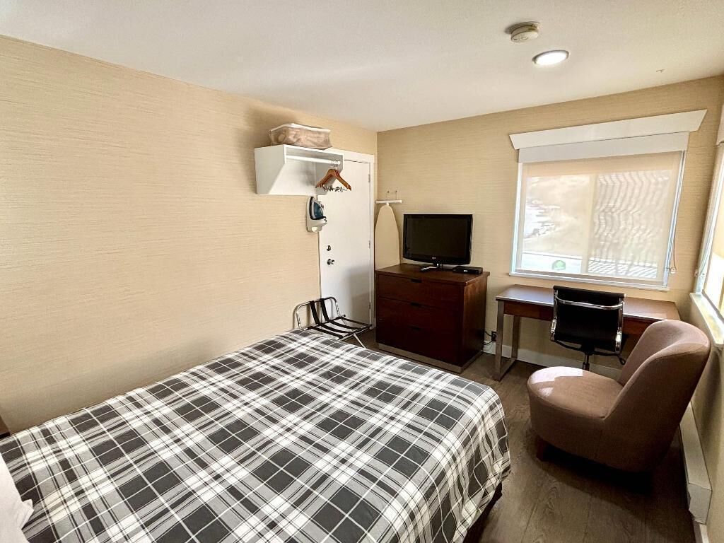 Premium bedding, desk, laptop workspace, blackout curtains
