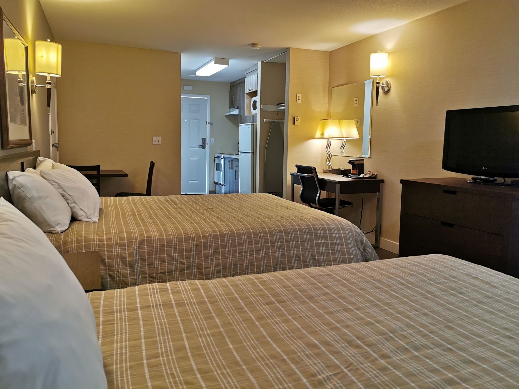 Premium bedding, desk, laptop workspace, blackout drapes