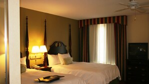 A hotel room with two beds, a ceiling fan, a television, and a nightstand with a lamp. - Hampton Inn Canton (Canton)