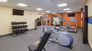 A gym with treadmills, elliptical machines, and a rack of dumbbells. - Hampton Inn Canton (Canton)