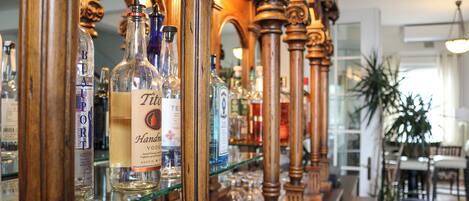 A bar area with shelves of liquor bottles and glasses.