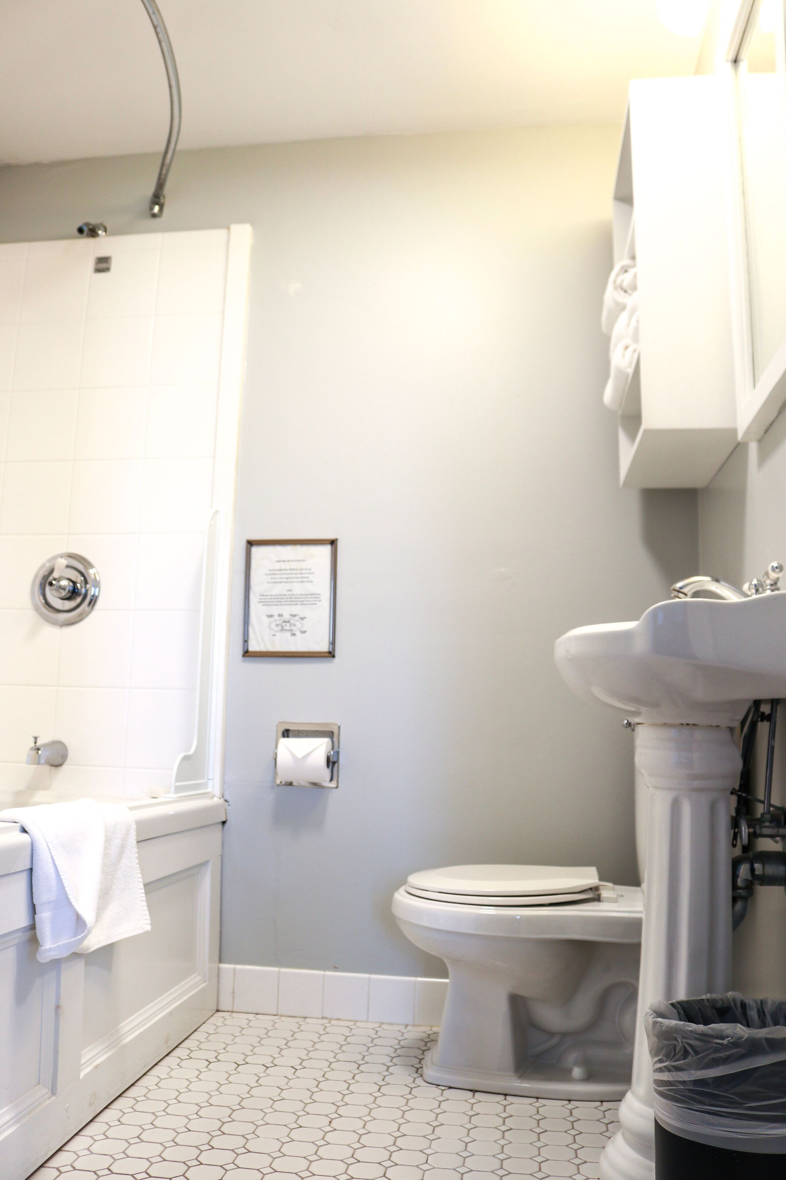 A bathroom with a white bathtub, a toilet, and a sink.